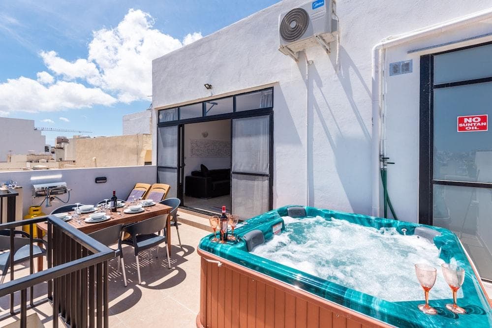 Summer Breeze Penthouse with Large Terrace And Hot Tub by Getaways Malta